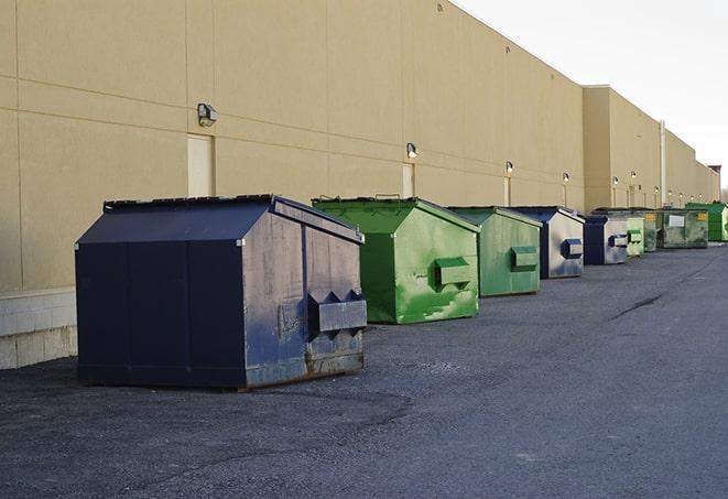 dumpsters lined up for use on busy construction site in Bernice